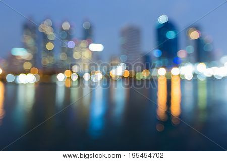 Blurred bokeh light offce building waterfront abstract background