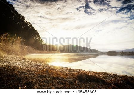 abstract morning fog on kawaguchiko lake and mount fuji with soft focus sun filter - can use to display or montage on product