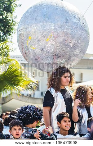 LIMASSOL, CYPRUS - FEBRUARY 26: Carnivalists in a silver cylinder hats joyfully follow the Limassol Municipality Band during the annual Carnival Parade, February 26, 2017 in Limassol.