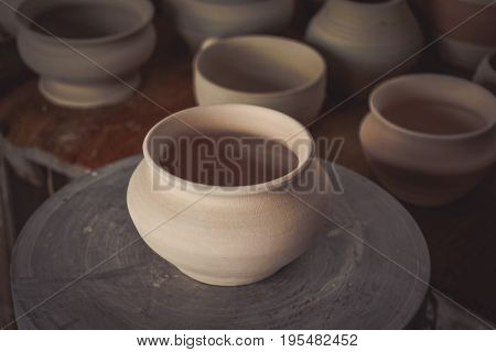 Clay pot on a potter's wheel close-up. Copy spase