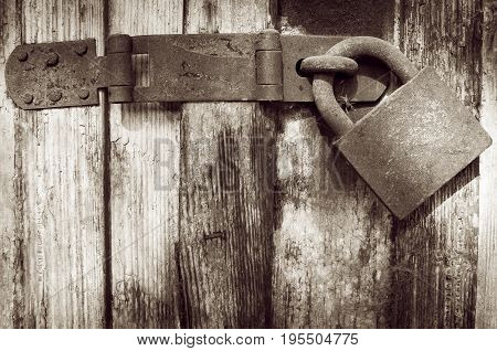 Padlock. Old rusty padlock on old wooden door
