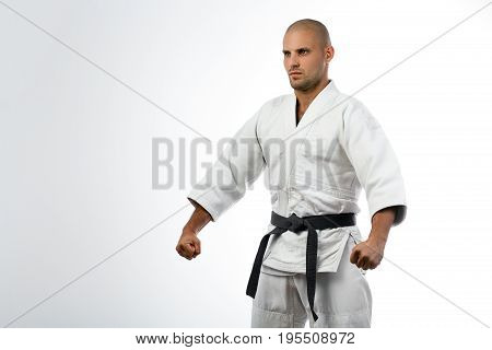Fighter In White Kimono Posing On Isolated
