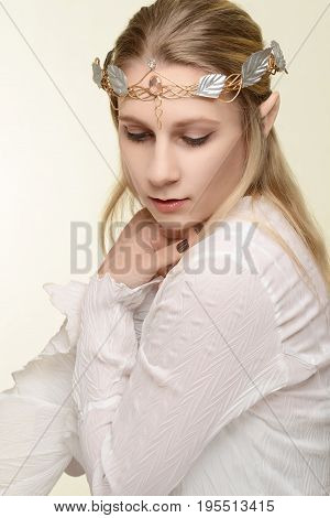 portrait of female elf with gold and silver crown