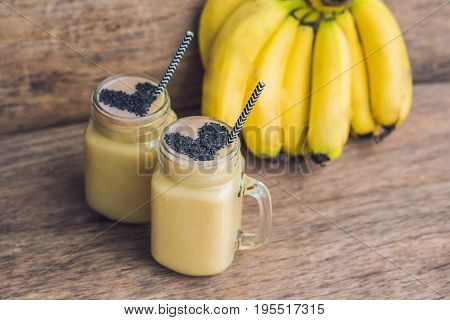 Banana Smoothies And Bananas On An Old Wooden Background