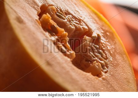 Half of ripe melon close up on blurred background.