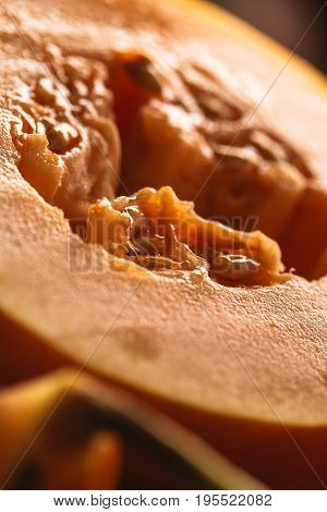 Half of ripe melon close up on blurred background.