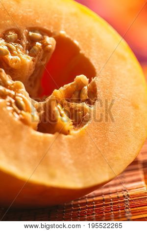 Half of ripe melon close up on blurred background.