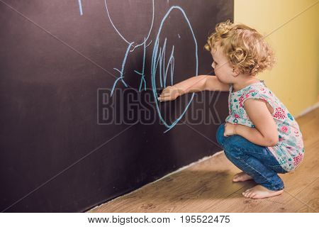 Girl Toddler Paint With Chalk On A Blackboard
