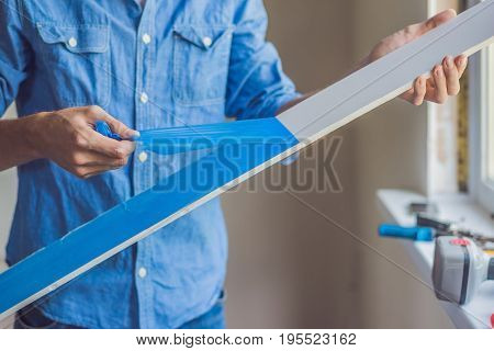 Man In A Blue Shirt Does Window Installation