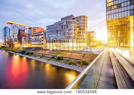 Night view on the modern financial district with illuminated buildings in Dusseldorf city, Germany