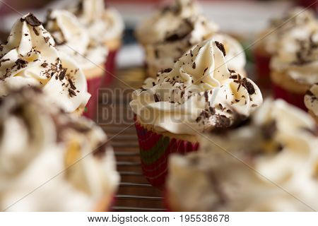 Baker Decorates Muffins With Cream And Confectionery Nozzles