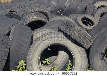 Pile of old used truck tires stocked for recycling