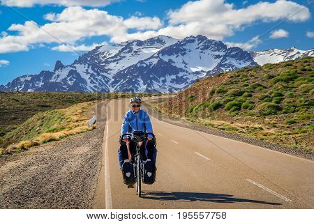 Woman cycling on the famous national Ruta 40 
 quarenta in central Argentina