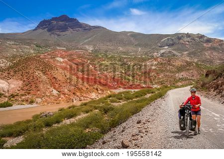 Woman cycling on the famous national Ruta 40 Quarenta in the remote part of central Argentina