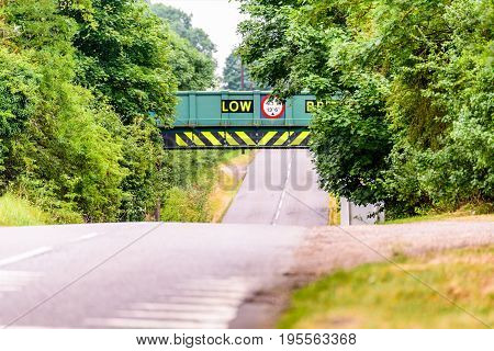 Day view of UK motorway highway under railway bridge.
