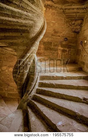 Lourmarin, France - July 07, 2016. View of stone staircase with dramatic light at Lourmarin castle, near the lovely village of Lourmarin. Vaucluse department, Provence region, southeastern France