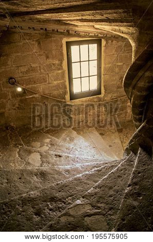 Lourmarin, France - July 07, 2016. View of stone staircase with dramatic light at Lourmarin castle, near the lovely village of Lourmarin. Vaucluse department, Provence region, southeastern France