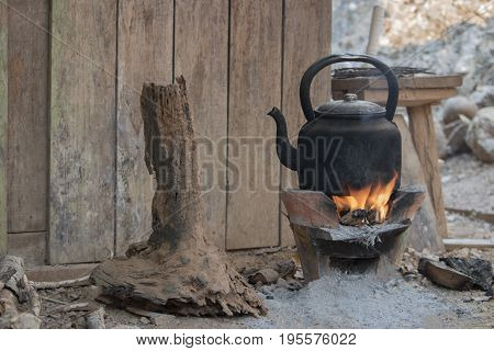 The kettle for gas is boiled on the brazier or pottery stove in the camp on the forest suitable for traveler to prepare fresh water or cook