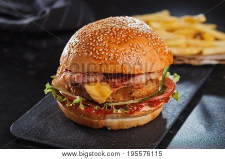 Burger Served With Fries On Stone Table