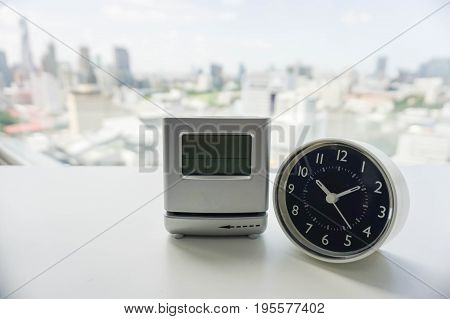 analog and digital modern clock on white table
