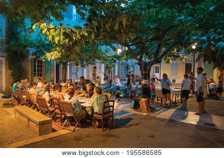 Rians, France - July 08, 2016. People dining in a square restaurant in the early evening, at the lovely village of Rians. Located in Var department, Provence region, in southeastern France.