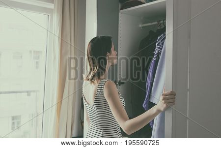 Young Rednead Girl Choosing A Clothes