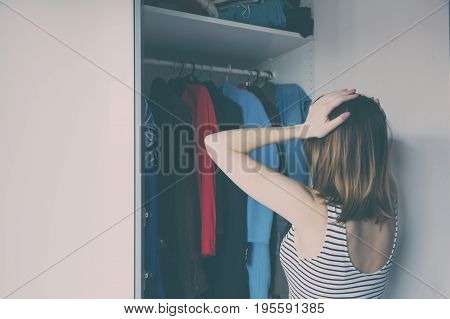 Young Rednead Girl Choosing A Clothes