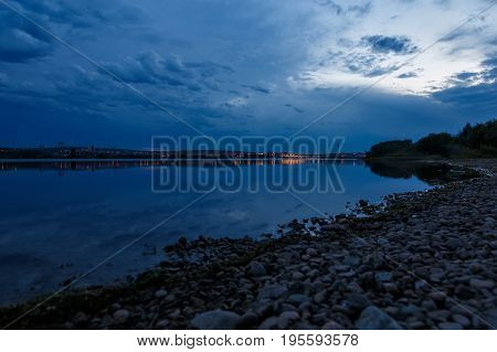 Sky after sunset at the bank of river Angara in Irkutsk with reflecton of clouds in water