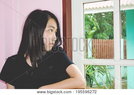 Depress And Hopeless Girl With Absent Minded Looking Outside