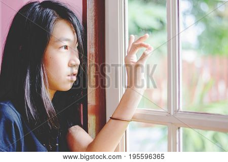 Depress And Hopeless Girl With Absent Minded Looking Outside