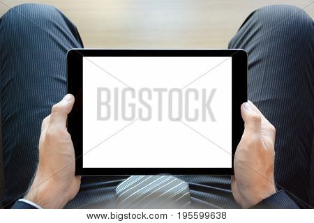 Sittiing businessman holding tablet pc with empty isolated screen