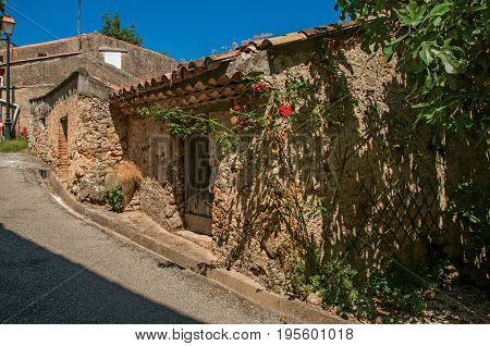 View of house in alley with sunny blue sky, in the quiet and graceful village of Sillans-la-Cascade, on the way to Draguignan. Located in the Provence region, Var department, southeastern France