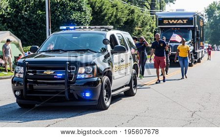 DUNWOODY GEORGIA - July 4 2016: Participants and spectators in the annual Dunwoody Georgia 4th of July parade which attracts over 2500 participants and 32000 spectators
