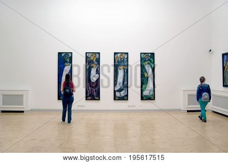 SAINT - PETERSBURG, RUSSIA - JULY 16, 2017: People look at the Four Evangelists and other paintings by Goncharova Natalia in The State Russian Museum
