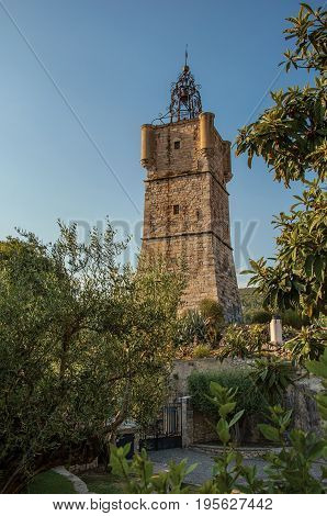 View of the clock tower made of stone on top of the hill with vegetation in the lively and gracious town of Draguignan. Located in the Var department, Provence region, southeastern France