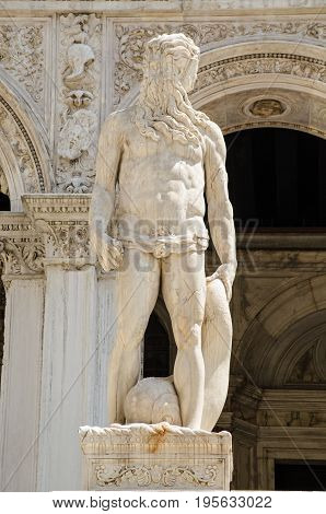 Statue of the Roman god of the sea - Neptune at the top of the Giants' Staircase to the historic Doge's Palace in Venice Italy. Sculpted by the Renaissance artist Jacopo Sansovino.