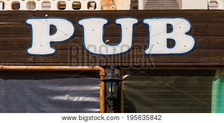 Pub Sign in Ireland in Summertime. inscription pub sign
