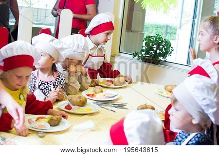 Alchevsk, Ukraine - July 16, 2017: Children's Master Class On Cooking Potatoes In The Oven With Ham 