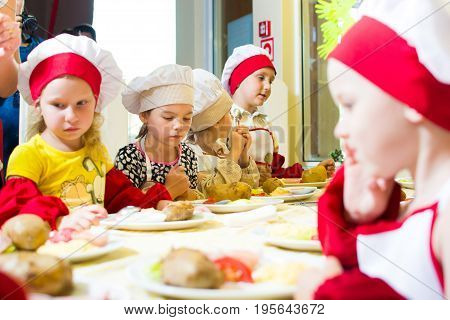 Alchevsk, Ukraine - July 16, 2017: Children's Master Class On Cooking Potatoes In The Oven With Ham 