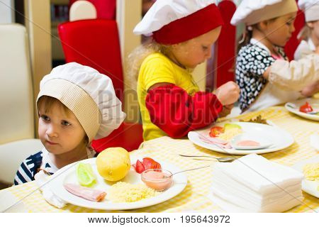 Alchevsk, Ukraine - July 16, 2017: Children's Master Class On Cooking Potatoes In The Oven With Ham 