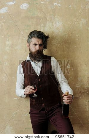 Man Holding Glass And Bottle Of Wine