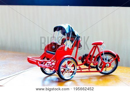 Three-wheeler Toy On Table The Transportation Concept.