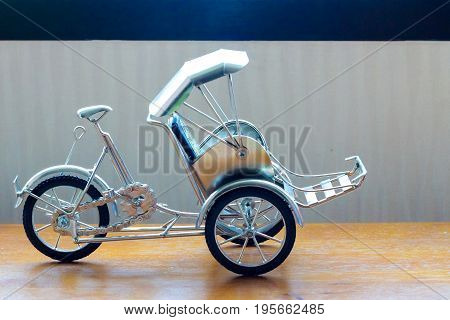 Three-wheeler Toy On Table The  Transportation Concept.