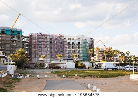 Protaras, Cyprus - February, 15, 2017. Construction's cars working on the construction of a new hotel in Protaras. Urban scene