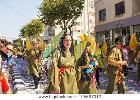 LIMASSOL, CYPRUS - FEBRUARY 26: Carnivalists in a silver cylinder hats joyfully follow the Limassol Municipality Band during the annual Carnival Parade, February 26, 2017 in Limassol.