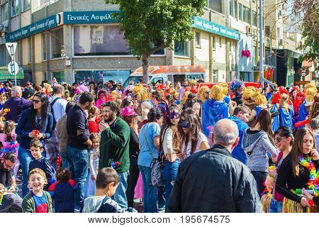 LIMASSOL, CYPRUS - FEBRUARY 26: Carnivalists in a silver cylinder hats joyfully follow the Limassol Municipality Band during the annual Carnival Parade, February 26, 2017 in Limassol.