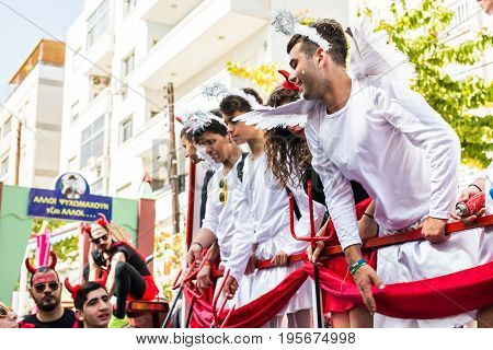 LIMASSOL, CYPRUS - FEBRUARY 26: Carnivalists in a silver cylinder hats joyfully follow the Limassol Municipality Band during the annual Carnival Parade, February 26, 2017 in Limassol.