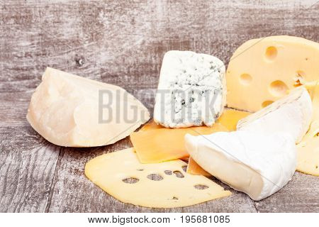 Different type of cheese on wooden background. Gourmet food apetizer