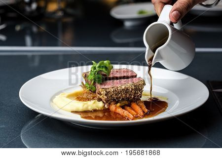 medium done grilled tuna steak in batter served with the baby carrot and mashpotato