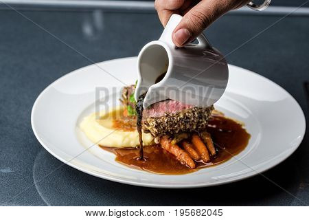medium done grilled tuna steak in batter served with the baby carrot and mashpotato
